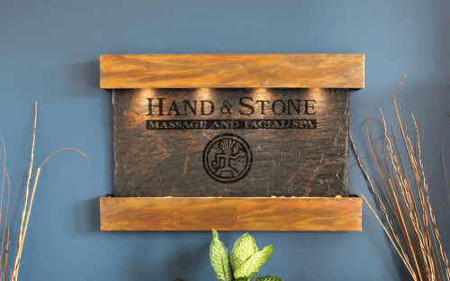 Luxurious Hand & Stone Massage and Facial Spa lobby sign